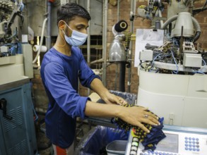 Employees of Inter Market Knit Private Limited producing socks. Lahore, 22.08.2024. Photographed on