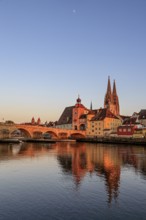 Church and bridge reflected in river, evening light, sunny, idyllic, Regensburg Cathedral and stone