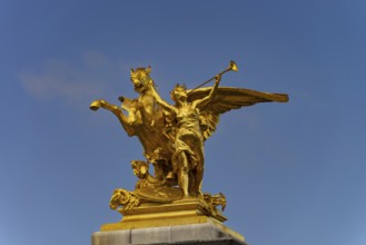 Column with the group of figures Fama of War on the Pont Alexandre III bridge over the Seine,