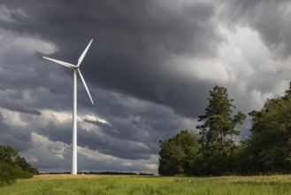 Wind turbine in front of dark storm clouds near Waldmössingen in the Black Forest. Wind energy.