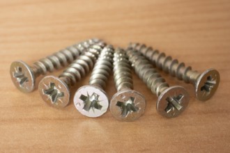 Phillips screws on wooden background, wood screws, spax screws