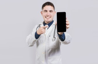 Smiling doctor showing an app on cell phone screen. Happy young doctor showing cell phone screen