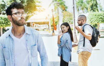 Distracted girlfriend looking at another man on the street. Unfaithful girlfriend looking at