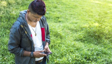 Close up of a man with cell phone in hand, close up of hands with cell phone with white screen,