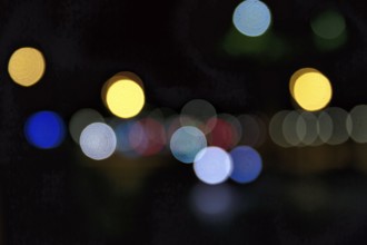 Bokeh balls, abstract dark background with blue and yellow lights, night shot, Barcelona, Spain,