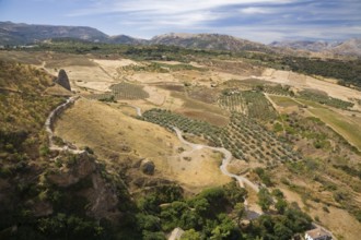 High angle view of valley with agricultural lands and mountains in the background in Ronda, Spain,