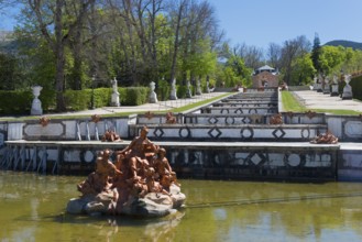 Baroque fountain with detailed sculptures in a park setting with green trees, Royal Castle La