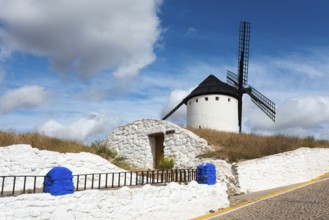 White windmill on a hill with blue sky in the background, Cueva de Mambrino, Craft Museum, Molino