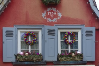 House facade with inscription built in 1758, red facade, Christmas decoration, window, window