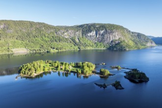 Single red house on island Oeyni in lake Bygdlandsfjord, aerial view, Setesdal valley, Norway,