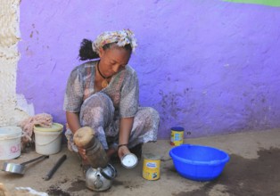 In the highlands of Abyssinia, in the village of Sina, young woman prepares coffee for the coffee