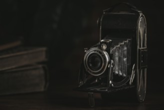 Unfolded antique bellows camera in a dark ambience