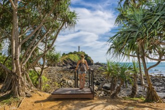 Tourist in Mu Ko Lanta National Park with view to the lighthouse in the south of the island,