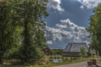 Former pig and poultry shed with pond on an estate, Othenstorf, Mecklenburg-Vorpommern, Germany,