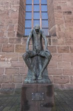 Bronze sculpture of Job, created by the German sculptor Gerhard Marcks in 1957, in front of St