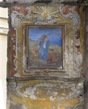 Image of the Virgin Mary in a historical frame in the arch of the Porta Soprana city gate, Via di