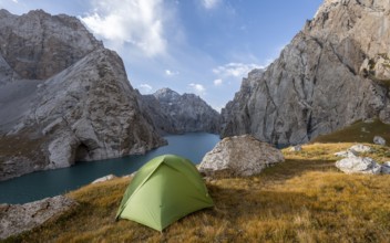 Wild camping, camping in the wilderness with a tent in front of mountain lake Kol Suu, Sary Beles