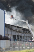 Firefighters, two firefighters with protective clothing and gas masks in aerial work platform,