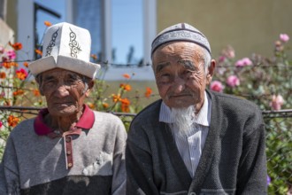 Portrait, two local elderly men with traditional hats, Issyk-Kul region, Kyrgyzstan, Asia