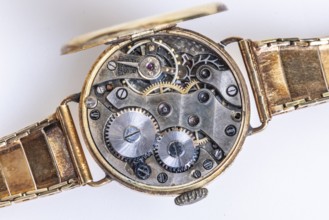 Opened old wristwatch shows the detailed inner movement