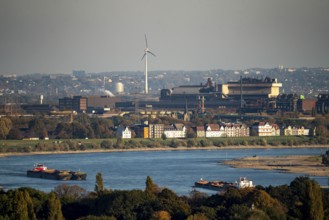 Cargo ships on the Rhine near Duisburg, houses on Deichstrasse, industrial backdrop of the