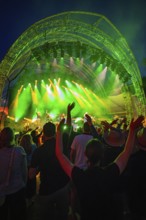 At night at the open-air concert with green lighting, crowd and stage, Klostersommer, Calw Hirsau,