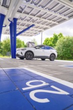 Electric car at charging points under a solar roof, ENBW charging park, Rutesheim, Germany, Europe