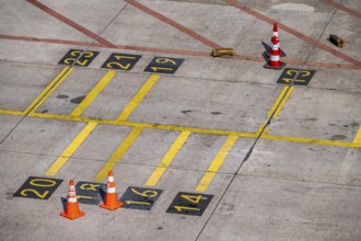 Park markings on the ground, at the terminal, in front of the passenger boarding bridge, holding