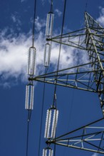 Insulators made of glass on a high-voltage line, they hang on the pylons as a suspension device