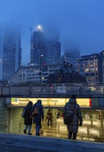 Rainy weather, freezing rain, entrance to Hauptwache underground station, high-rise skyline in