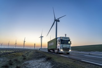 Lorry on the road to Euromax Terminal Rotterdam, ENECO wind farm on the dike around the port of