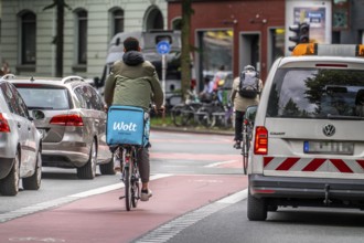 Bicycle lane, marked red, between 2 lanes for vehicles, city centre traffic, Dortmund, North