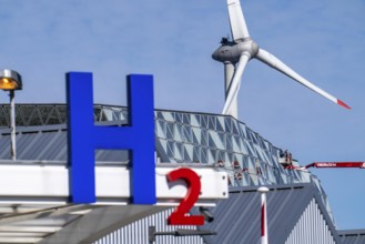 Hydrogen filling station in Antwerp, for cars and lorries, H2 lettering, wind turbine in the