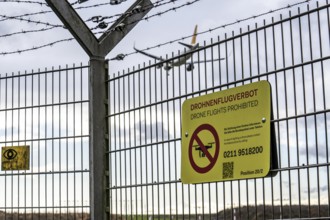 Düsseldorf International Airport, security fence at the border of the airport, runway, notice on