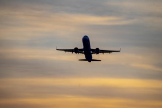 Düsseldorf International Airport, sunset, aircraft taking off from the main runway south, 05R/23L,