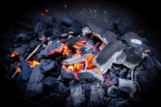 Close-up of glowing charcoal with glowing sparks