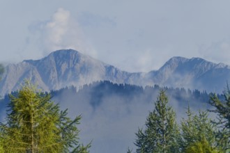 Karawanken, mountains in Slovenia in the background with clouds and fog in the foreground with