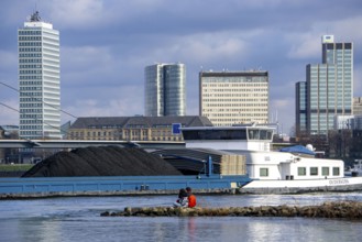 The Rhine near Düsseldorf, cargo ship, coal freighter, skyline, Rhine knee bridge, North