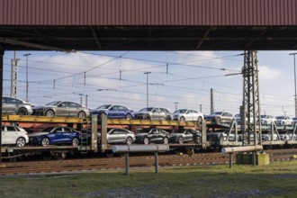 Car train, goods train on its way to the car terminal in Bremerhaven seaport, new German cars for