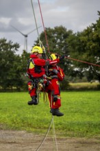 Height rescuers from the Gelsenkirchen fire brigade practise abseiling from a wind turbine from a