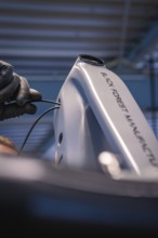 Wiring detail on a light-coloured bicycle frame in a workshop, Waldbike Manufaktur, bicycle