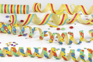 Colourful streamers and confetti on a white background, carnival