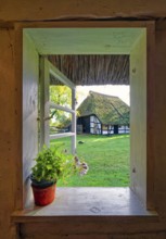 Window of a historic farmhouse with a view of another historic farmhouse, Klockenhagen Open-Air