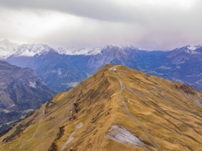 A sweeping view over autumnal Alpine peaks under a slightly cloudy sky, Alpen Tower, Switzerland,