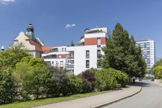 Old and new, historic craftsmen's school, modern apartment block and new building block from GDR