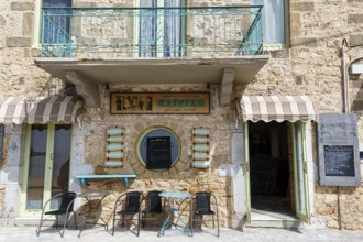 Facade of a bakery with café, typical stone house in Stoupa, former fishing village, Mani, Greece,