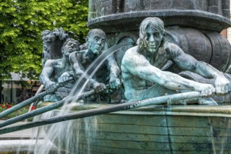 Detail of the historical column of the fountain on Josef-Görres-Platz in the historic centre of