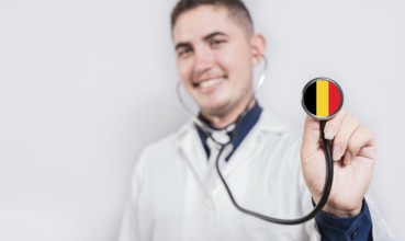 Young doctor showing stethoscope with Belgium flag. Belgium National Healthcare concept