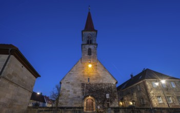 St Bartholomew's Church with poinsettia at dusk, Eschenau, Middle Franconia, Bavaria, Germany,