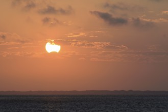 Sunset over the North Sea, on the horizon the contours of the island of Juist, Norddeich, Lower